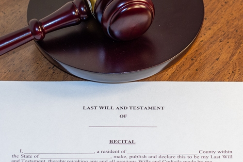Judges gavel next to a last will and testament symbolizing contesting a will